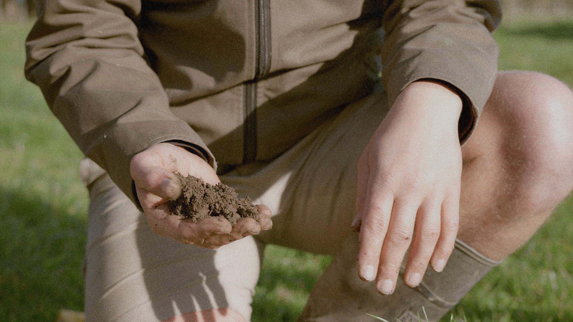 Hands holding soil, showing the connection between farmers and their land